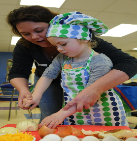 Mother teaching daughter cooking