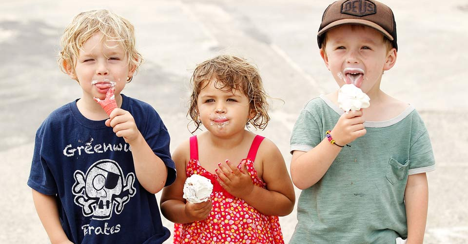 Three children eating ice cream cones